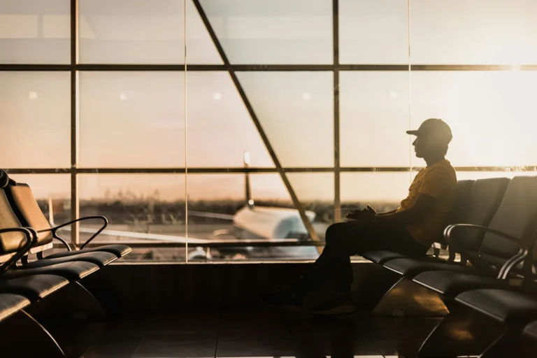A passenger waiting for a flight in the airport departure hall